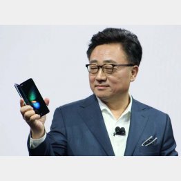 折り畳めるスマートフォン「ギャラクシーフォールド」を手にするサムスン電子幹部／（Ｃ）共同通信社