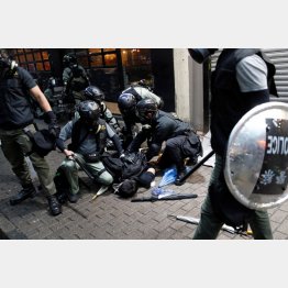 デモ参加者を拘束する警察官ら（Ｃ）ロイター