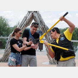 手錠を切断してもらう二人（Ｃ）ロイター