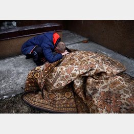 ロシア軍に射殺された友人の遺体にすがり悲痛な叫びを上げる男性（Ｃ）ロイター