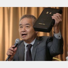 「聖本」を掲げる渡辺博弁護士（Ｃ）日刊ゲンダイ