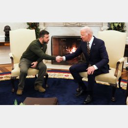 会談で、固く握手をするウクライナのゼレンスキー大統領（左）とバイデン米大統領（Ｃ）ロイター