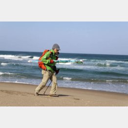 のぼりを脇に抱えて歩き続ける（Ｃ）Dr.カキゾエ歩く処方箋映画製作委員会2024年